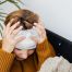 woman holding her bandaged head